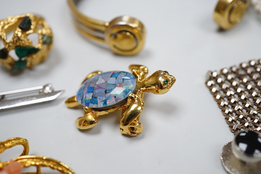 A collection of costume jewels, comprising: a floral coral and nephrite brooch; a composite opal triplet brooch designed as a turtle; a textured gilt metal ring set with hardstone fragments; a cultured pearl and chrysopr